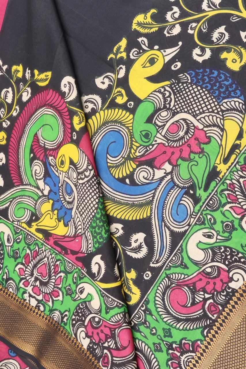 Classic black Kalamkari accented by a striking multi colored border with intricate gold zari work