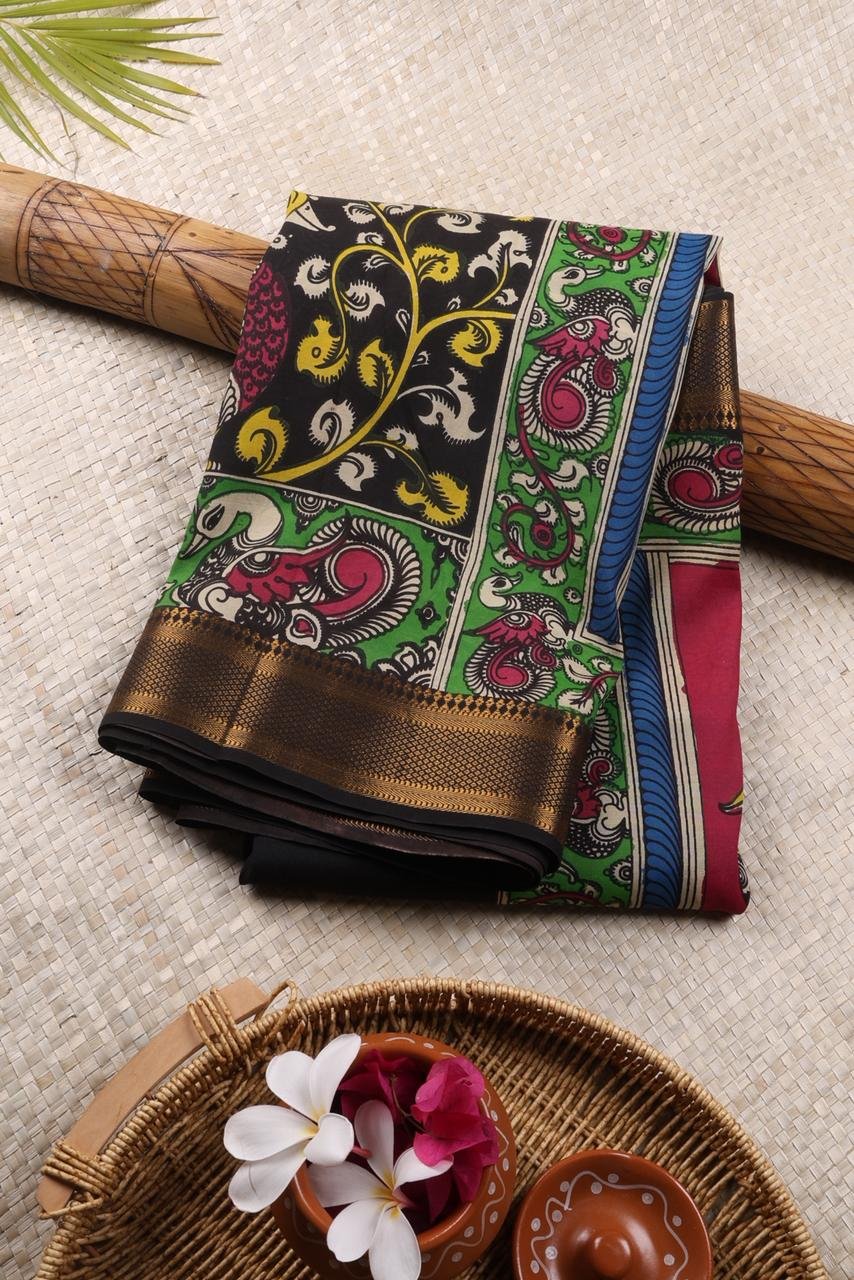 Classic black Kalamkari accented by a striking multi colored border with intricate gold zari work