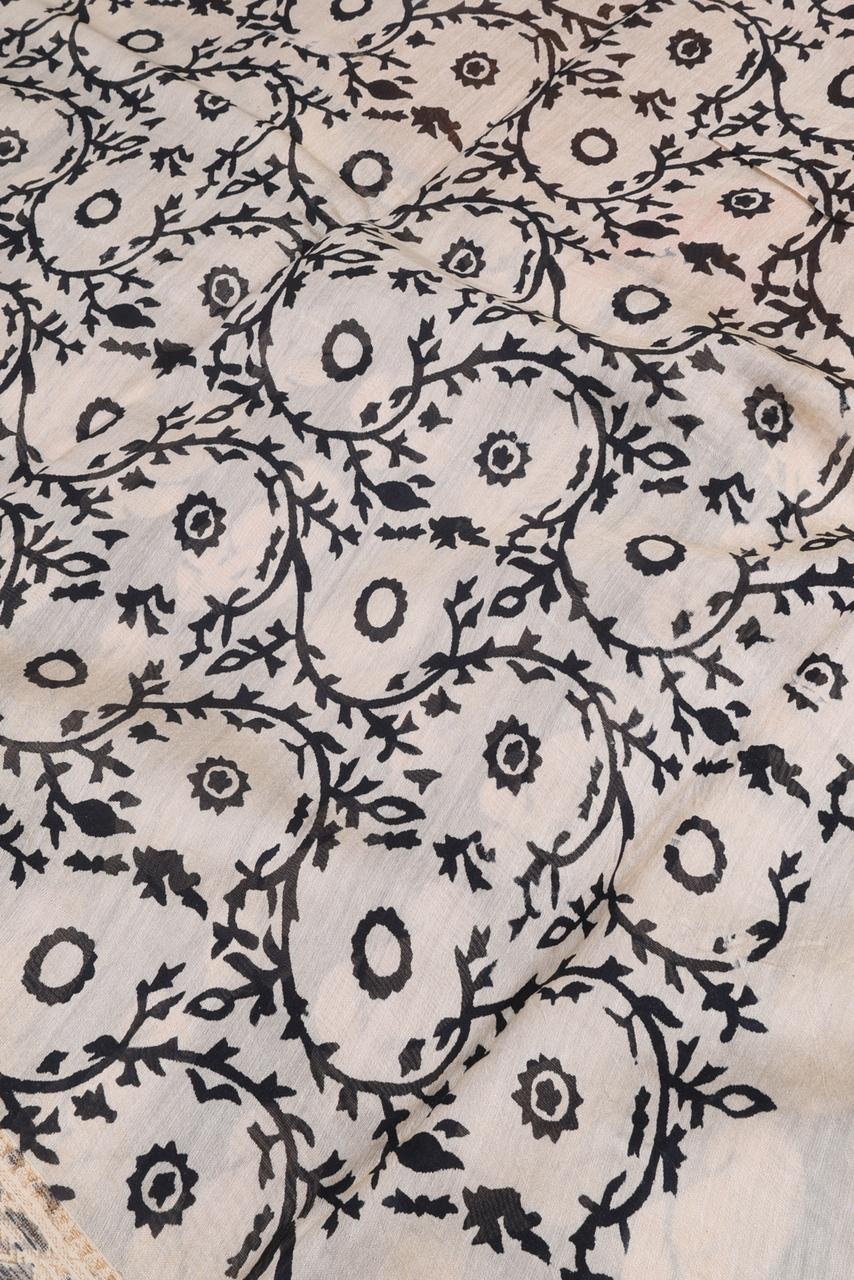 Maheshwari saree features a bold black body adorned with cream-colored floral motifs perfectly contrasted by a vibrant mustard-gold pallu