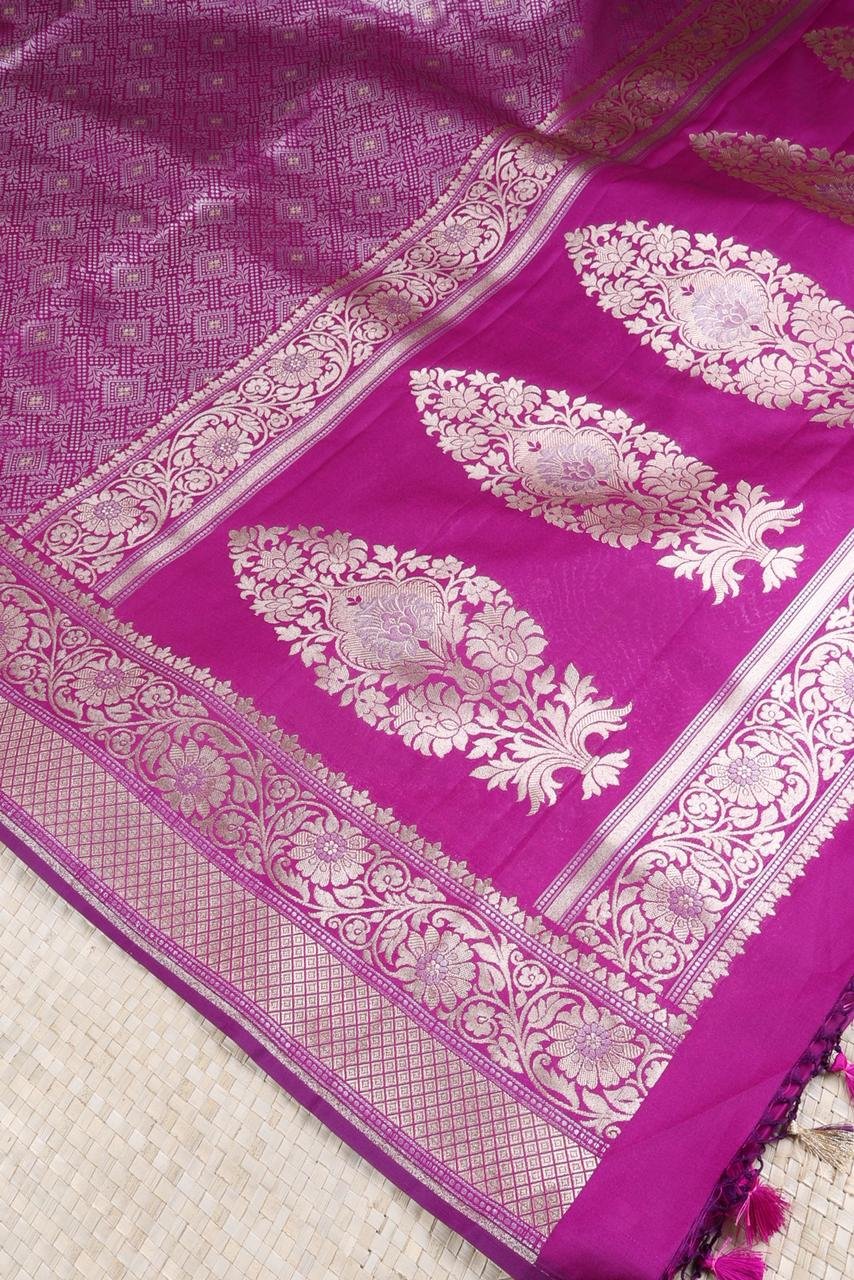 Purple Banarasi saree features intricate silver floral motifs woven throughout the body