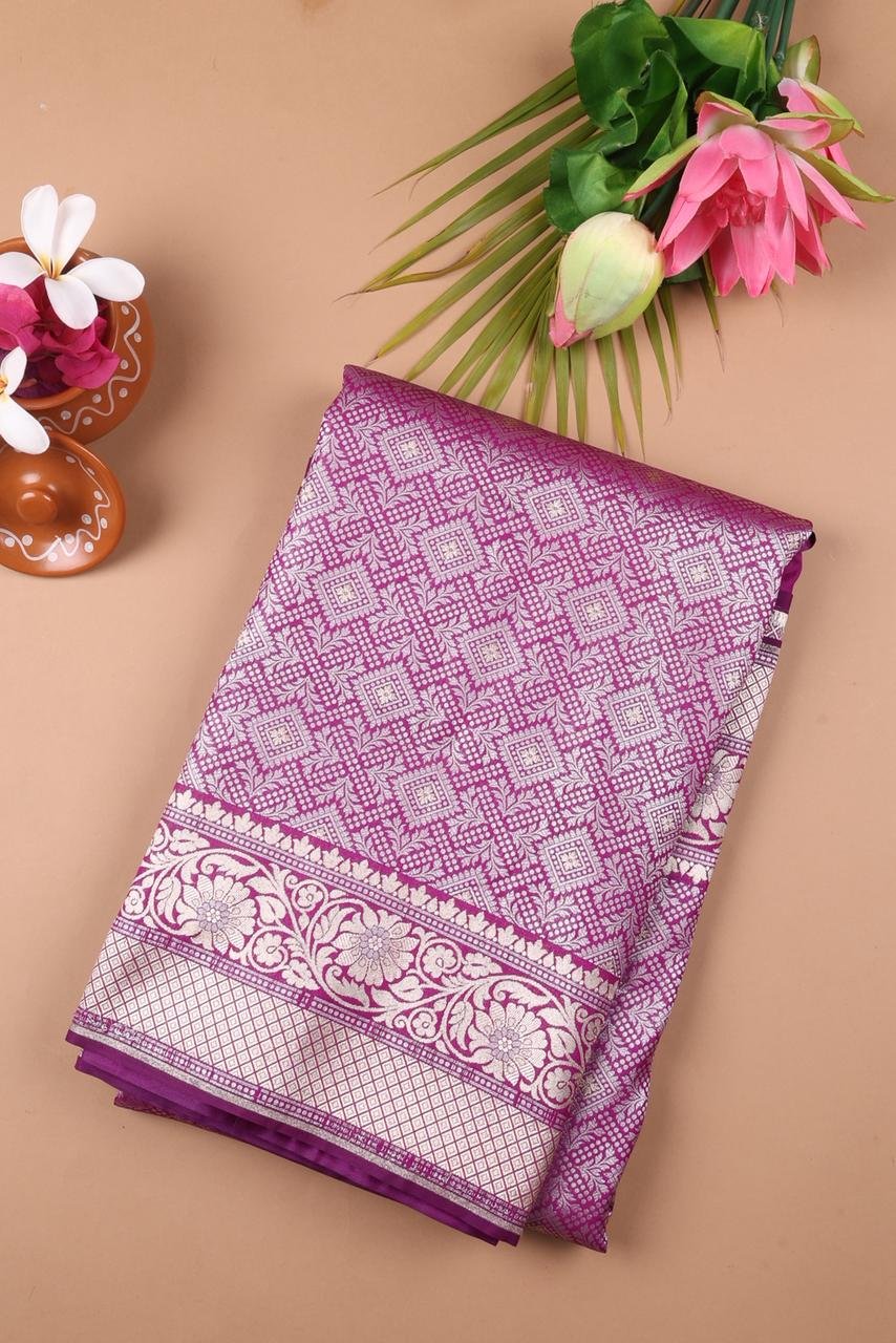 Purple Banarasi saree features intricate silver floral motifs woven throughout the body
