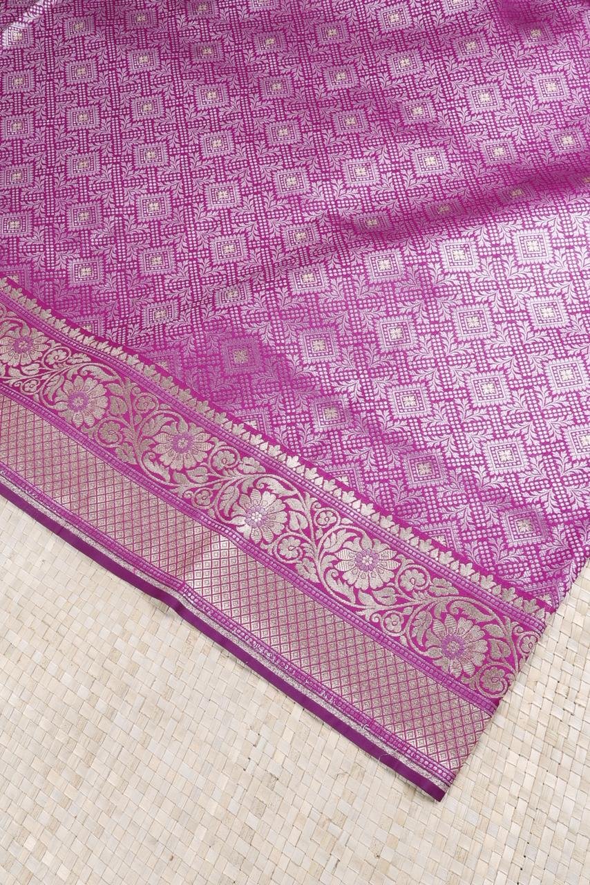 Purple Banarasi saree features intricate silver floral motifs woven throughout the body