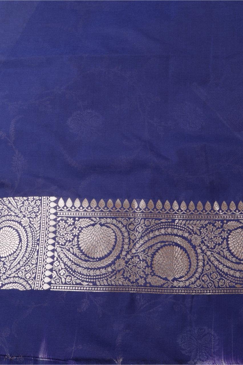 Royal Blue Banarasi saree features intricate silver floral motifs woven throughout the body