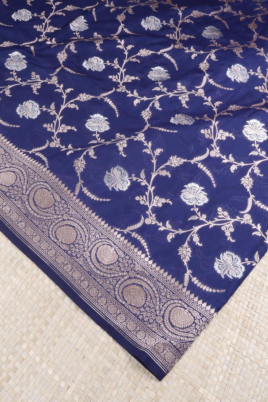Royal Blue Banarasi saree features intricate silver floral motifs woven throughout the body