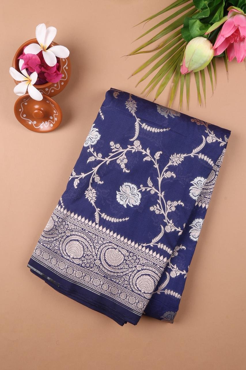 Royal Blue Banarasi saree features intricate silver floral motifs woven throughout the body
