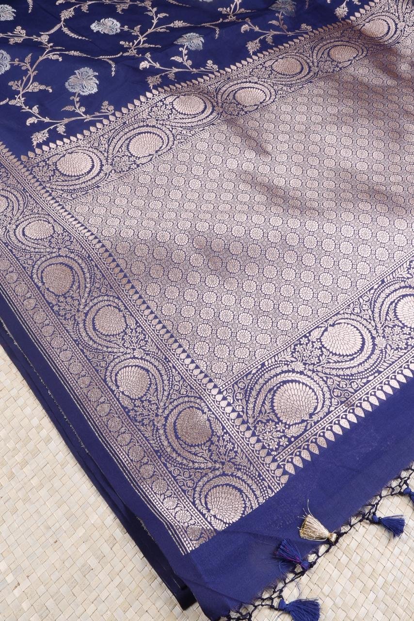 Royal Blue Banarasi saree features intricate silver floral motifs woven throughout the body