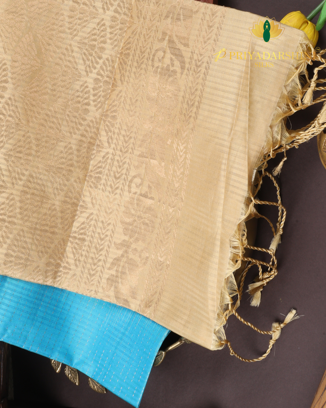 Experience the beautiful contrast of a vibrant aqua blue body meeting a majestic antique gold beige border and pallu. This premium soft silk saree features delicate metallic stripes and timeless traditional motifs.