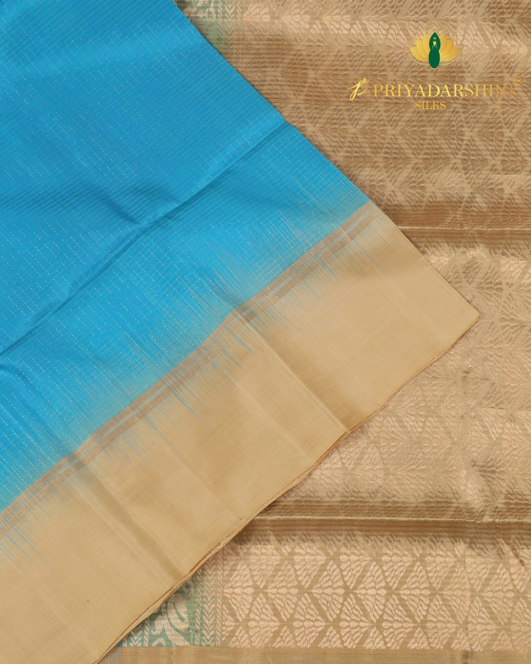 Experience the beautiful contrast of a vibrant aqua blue body meeting a majestic antique gold beige border and pallu. This premium soft silk saree features delicate metallic stripes and timeless traditional motifs.