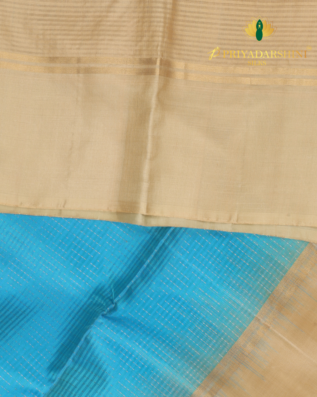Experience the beautiful contrast of a vibrant aqua blue body meeting a majestic antique gold beige border and pallu. This premium soft silk saree features delicate metallic stripes and timeless traditional motifs.